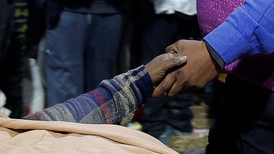 <div class="paragraphs"><p>   A man holds the hand of a victim after a deadly stampede before the second Shahi Snan , at the Maha Kumbh Mela</p></div>