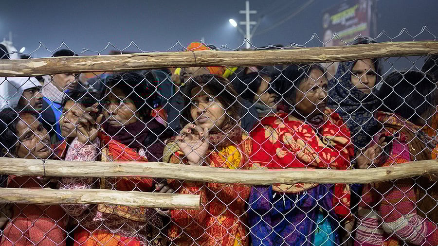 <div class="paragraphs"><p>Devotees react after being stopped by policemen, after a deadly stampede</p></div>