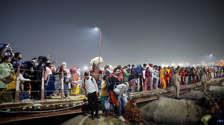 <div class="paragraphs"><p>Devotees walk from a pontoon bridge after a deadly stampede before the second 'Shahi Snan'&nbsp; at the 'Maha Kumbh Mela'</p></div>