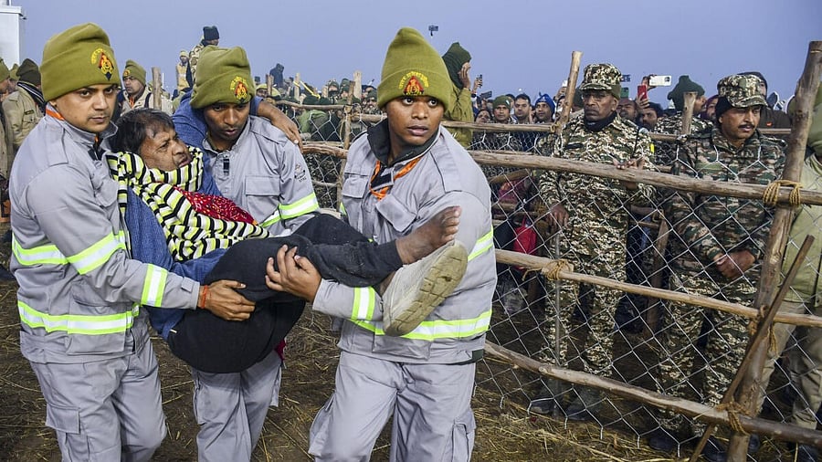 <div class="paragraphs"><p>UP Fire and Emergency Services personnel rescue a person during after the stampede in Prayagraj.&nbsp;</p></div>