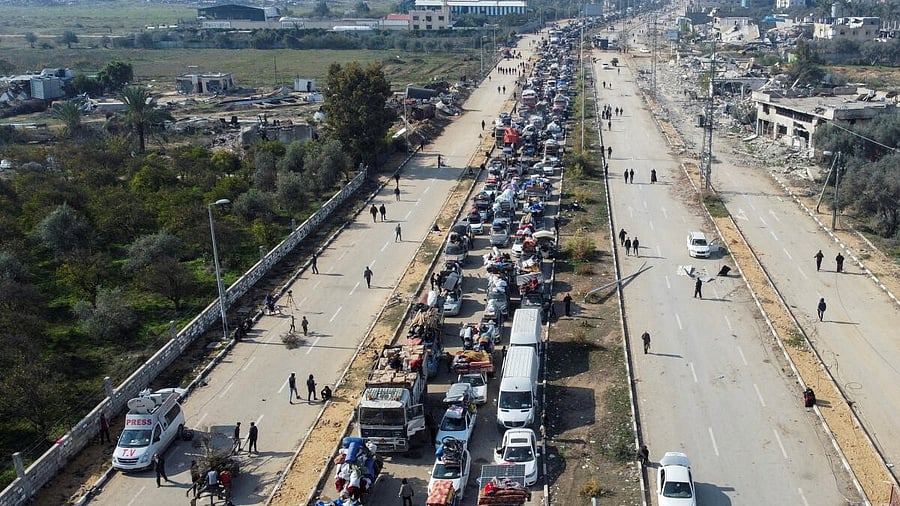 <div class="paragraphs"><p> A drone view shows displaced Palestinians waiting to have their vehicles inspected by the Egyptian-Qatari committee as they return to their homes in northern Gaza from the south, at Salahudeen Road, amid a ceasefire between Israel and Hamas, in the central Gaza Strip.</p></div>