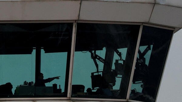 <div class="paragraphs"><p>People work inside air traffic control at Ronald Reagan Washington National Airport, in the aftermath of the collision of American Eagle flight 5342 and a Black Hawk helicopter that crashed into the Potomac River, in Arlington, Virginia.</p></div>