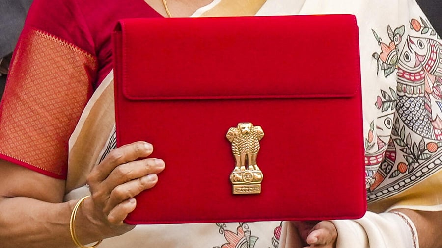 <div class="paragraphs"><p>Union Finance Minister Nirmala Sitharaman shows a tablet, wrapped in a red cover, containing Union Budget 2025-26 documents before its presentation at the Parliament House complex, in New Delhi, Saturday, Feb. 1, 2025.</p></div>