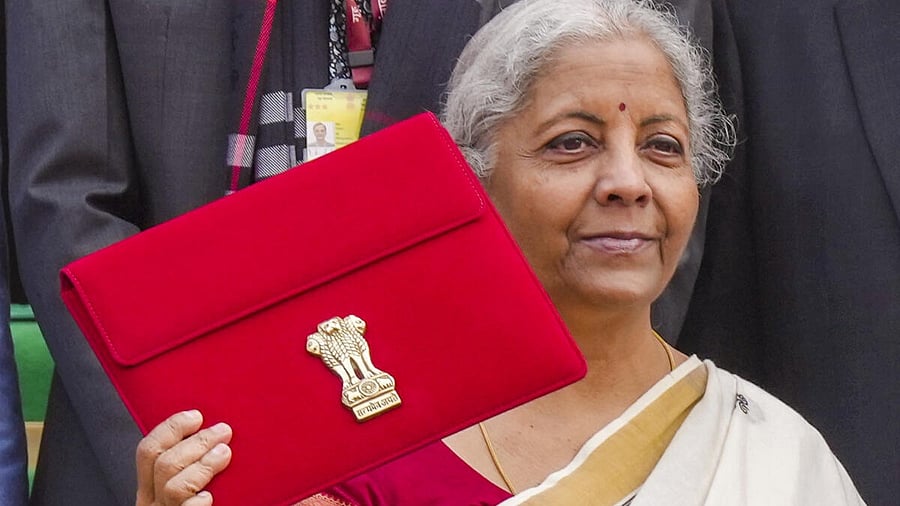 <div class="paragraphs"><p>Union Finance Minister Nirmala Sitharaman shows a tablet, wrapped in a red cover, containing Union Budget 2025-26 documents before its presentation at the Parliament House complex, in New Delhi, Saturday, Feb. 1, 2025.</p></div>