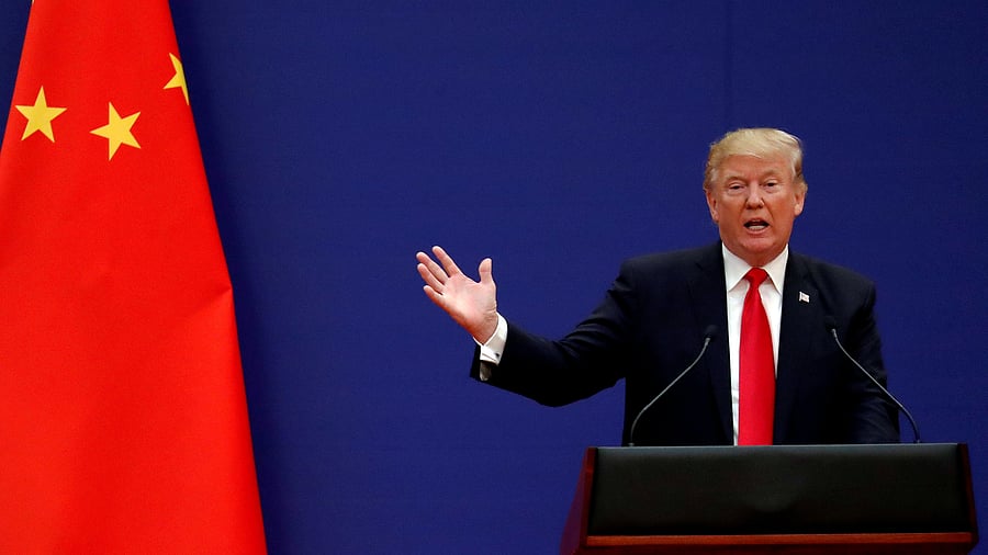 <div class="paragraphs"><p>The Chinese flag and US President Donald Trump is seen in this file photo.</p></div>