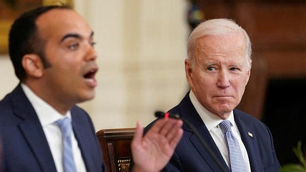 <div class="paragraphs"><p>Former US President Joe Biden listens to Director of the Consumer Financial Protection Bureau Rohit Chopra</p></div>