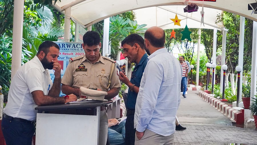 <div class="paragraphs"><p>A security personnel at a  polling booth in New Delhi.( File image)</p></div>
