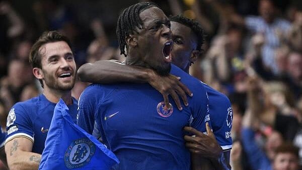 <div class="paragraphs"><p>Axel Disasi (in front) celebrates with Chelsea teammates during a Premier League match.</p></div>