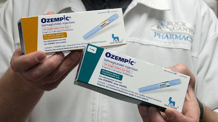 <div class="paragraphs"><p>A pharmacist displays boxes of Ozempic</p></div>