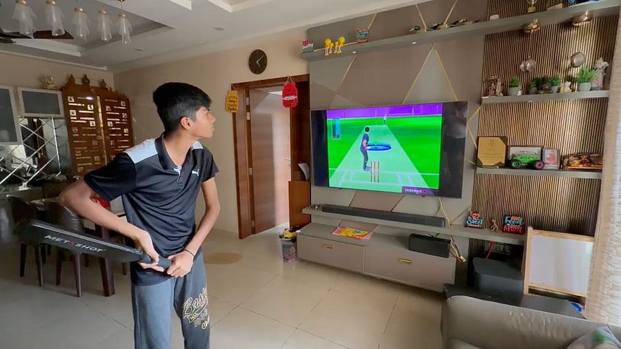 <div class="paragraphs"><p>A boy plays a game of simulated cricket with the MetaShot bat at his home in north Bengaluru. </p></div>