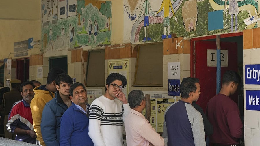 <div class="paragraphs"><p>Voters wait in a queue to cast votes during the Delhi Assembly elections</p></div>