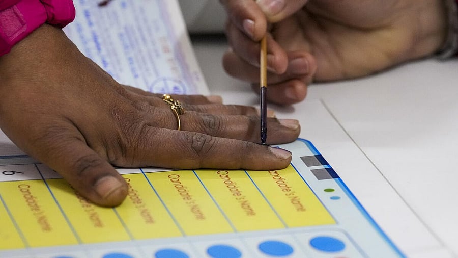 <div class="paragraphs"><p>A voter gets her finger marked with indelible ink before casting vote at a polling booth during Delhi Assembly elections, at Lodhi Estate in New Delhi, Wednesday, Feb. 5, 2025.</p></div>