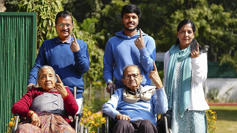 <div class="paragraphs"><p>Former Delhi chief minister and Aam Aadmi Party (AAP) National Convener Arvind Kejriwal and his mother Gita Devi, father Gobind Ram Kejriwal, wife Sunita and son Pulkit show their fingers marked with indelible ink after casting votes during the Assembly elections, in New Delhi.</p></div>