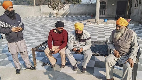<div class="paragraphs"><p>Swaran Singh, father of Akashdeep Singh, one of the Indian immigrants deported from US, with relatives at his residence in the border village of Rajatal, in Amritsar district, Thursday, Feb. 6, 2025.</p></div>