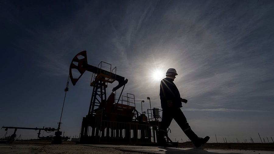 <div class="paragraphs"><p>An oil and gas industry worker walks during operations of a drilling rig.</p></div>