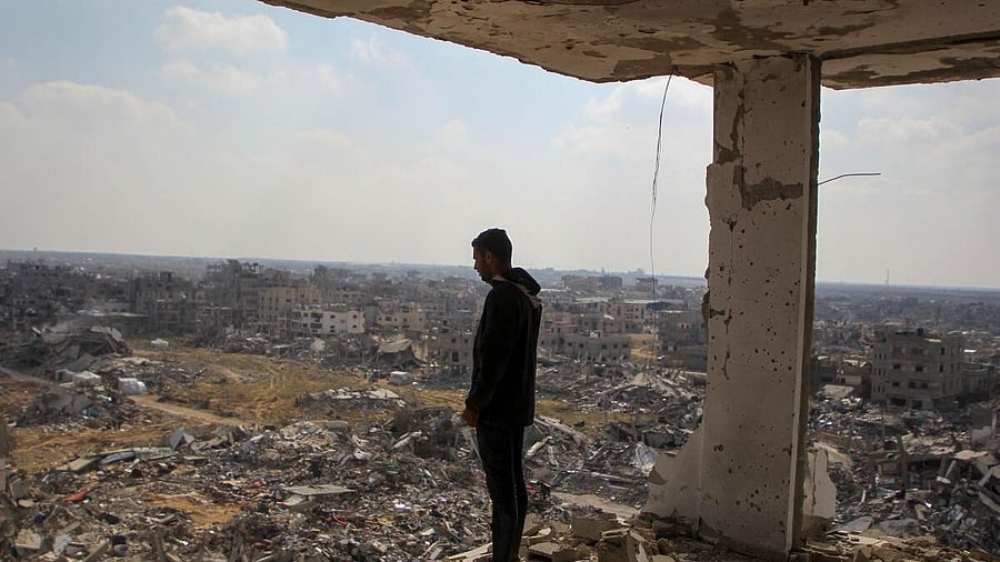 <div class="paragraphs"><p>A Palestinian man views the rubble of buildings destroyed during the Israeli offensive, amid a ceasefire between Israel and Hamas, in Rafah in the southern Gaza Strip.</p></div>