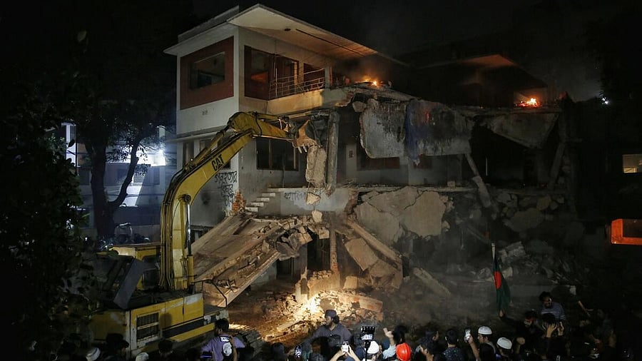 <div class="paragraphs"><p>Protesters use an excavator to demolish the Dhanmondi-32 residence of Bangabandhu Sheikh Mujibur Rahman, father of the ousted PM Sheikh Hasina</p></div>