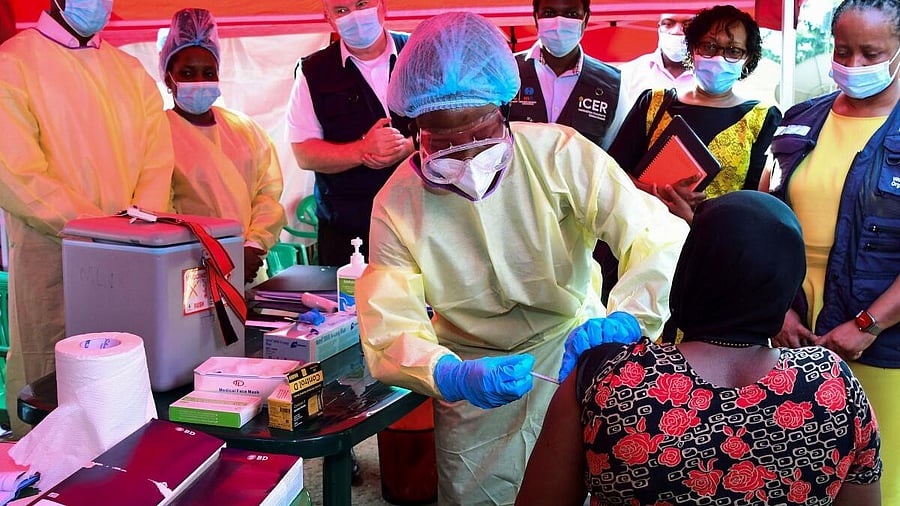 <div class="paragraphs"><p>A Ugandan doctor vaccinates the contact of a patient who tested positive during the launch of the vaccination for the Sudan strain of the Ebola virus with a trial vaccine at the Mulago Guest House (Isolation centre) in Kampala, Uganda.</p></div>