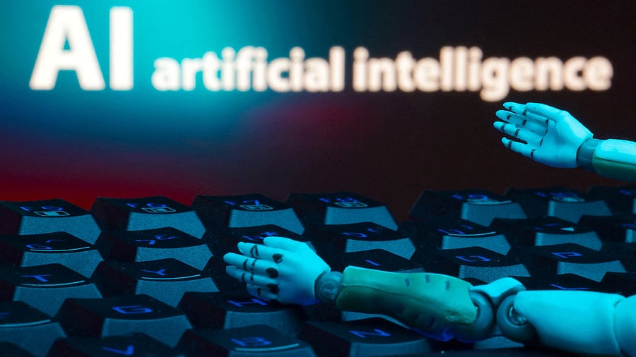 <div class="paragraphs"><p> A message reading "AI artificial intelligence", a keyboard, and robot hands are seen in this illustration taken January 27, 2025. </p></div>