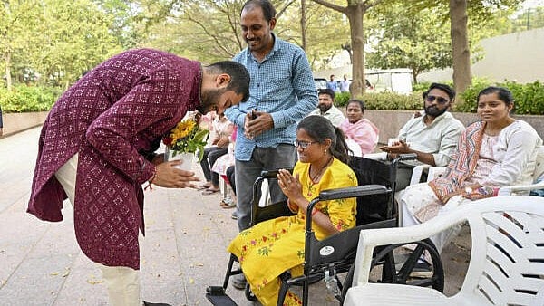 <div class="paragraphs"><p>Industrialist Gautam Adani's son Jeet Adani meets a 'divyang' couple during a function to announce 'Mangal Seva' ahead of his wedding ceremony. The 'seva' aims to provide Rs 10 lakh annually to support the marriages of 500 women with disabilities.</p></div>