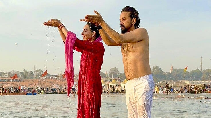 <div class="paragraphs"><p>Anurag Thakur along with his wife takes a dip at Sangam in Prayagraj. </p></div>
