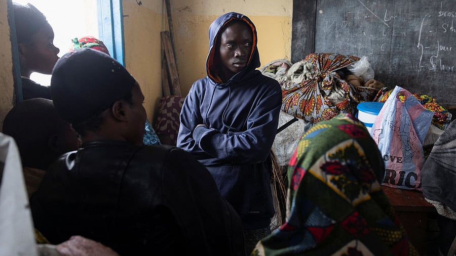 <div class="paragraphs"><p>Displaced people wait at a school where they are taking refuge after their camp in Kanyaruchinya was destroyed, after the town of Goma was taken by the M23 rebels, in Kanyaruchinya, Democratic Republic of Congo.</p></div>