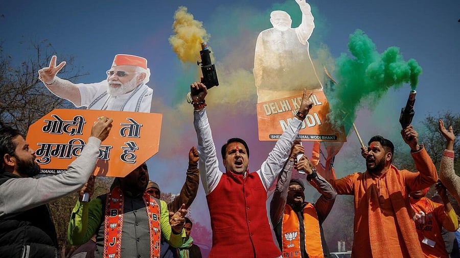 <div class="paragraphs"><p>BJP supporters celebrate outside the party headquarters in New Delhi.&nbsp;</p></div>