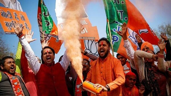 <div class="paragraphs"><p>Bharatiya Janata Party (BJP) supporters celebrate outside the BJP state headquarters, as BJP is projected leading in the election results in Delhi.</p></div>