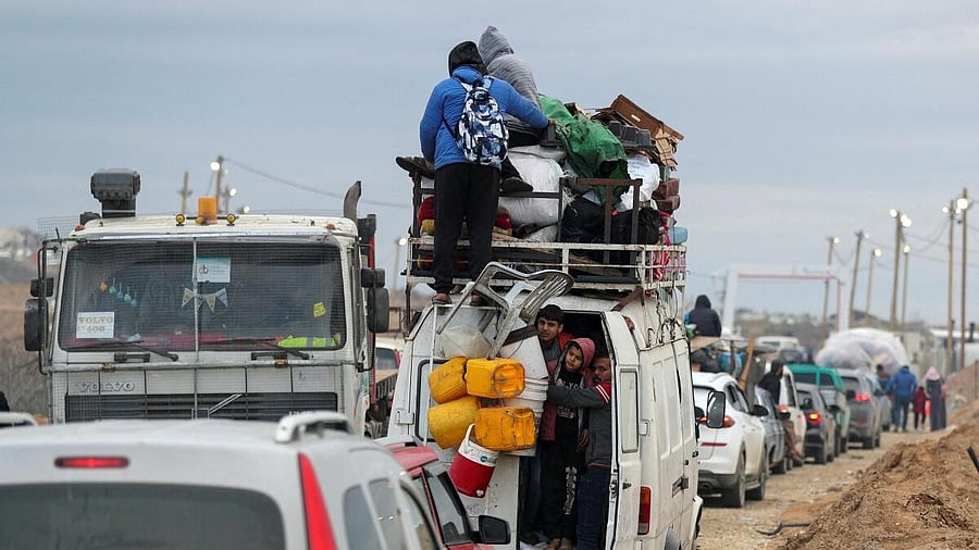 <div class="paragraphs"><p>Palestinians make their way after Israeli forces withdrew from the Netzarim Corridor, near Gaza City</p><p></p></div>