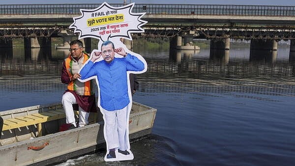 <div class="paragraphs"><p>BJP Parvesh Verma with a cutout of AAP National Convenor Arvind Kejriwal reaches Yamuna Ghat, protesting over the issue of Yamuna cleaning, in New Delhi.</p></div>