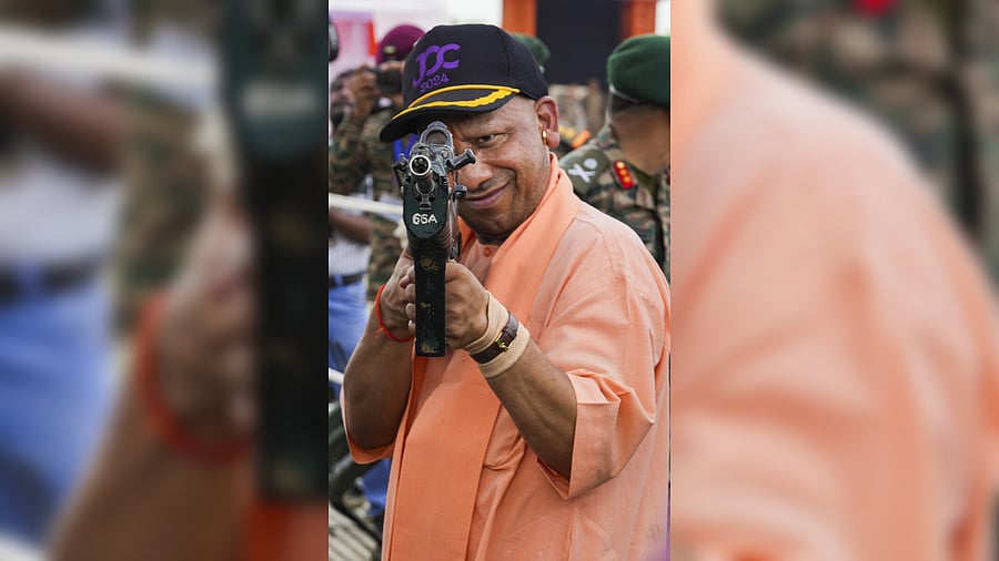 <div class="paragraphs"><p>Uttar Pradesh Chief Minister Yogi Adityanath views a gun at the Armed Force Festival, in Lucknow, Tuesday, Sept. 3, 2024.</p></div>