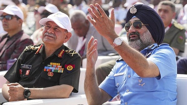 <div class="paragraphs"><p>Chief of Air Ataff Air Chief Marshal A P Singh and Army Chief Upendra Dwivedi watch the fly-past during the inauguration of the 15th edition of Aero India 2025 at Yelahanka Airbase in Bengaluru, Karnataka, Monday.</p></div>
