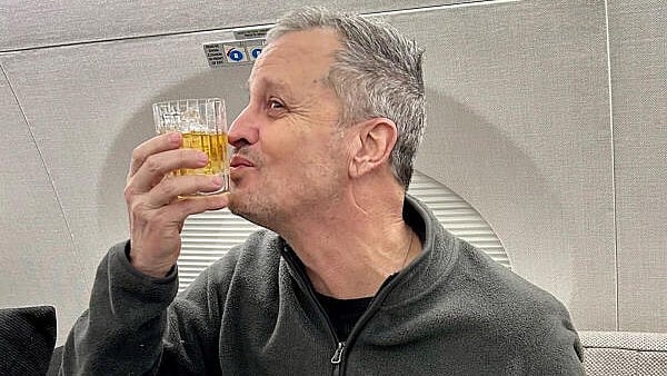 <div class="paragraphs"><p>Marc Fogel, an American schoolteacher detained in Russia since August 2021, gestures on an airplane flying him back to the United States after U.S. special envoy Steve Witkoff secured his release February 11, 2025.</p></div>
