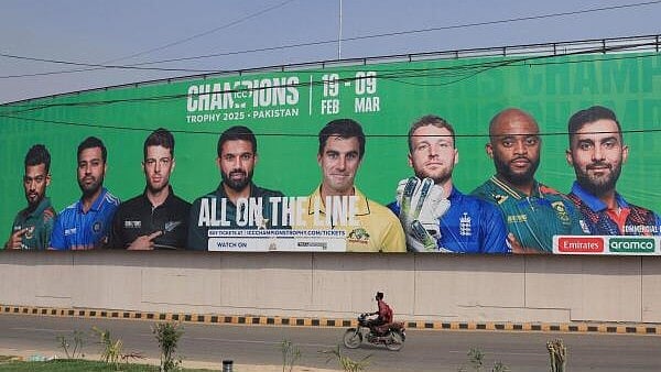 <div class="paragraphs"><p>A person rides on a motorbike past a wall with a billboard advertisment ahead of the ICC Champions Trophy 2025 tournament, in Karachi</p></div>