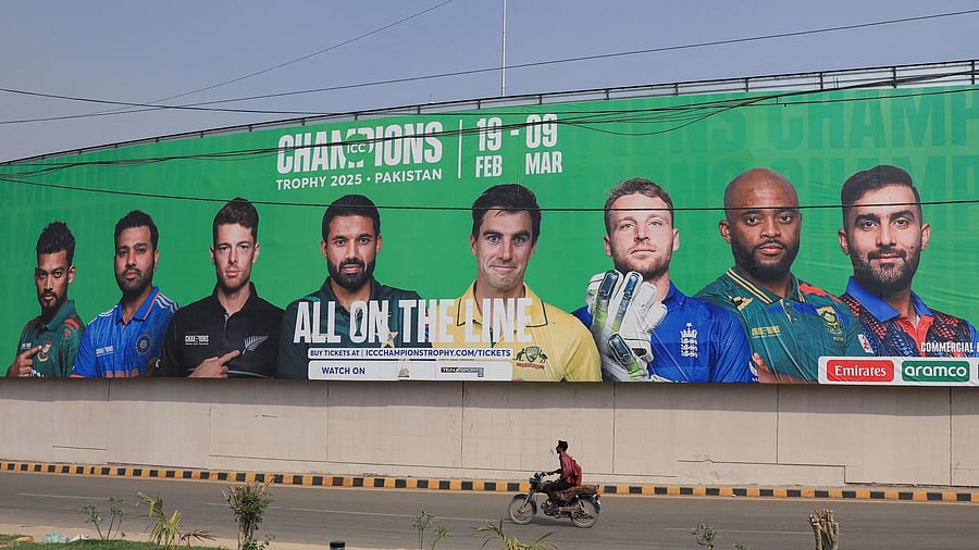 <div class="paragraphs"><p>A person rides on a motorbike past a wall with a billboard advertisement ahead of the ICC Champions Trophy 2025 tournament, in Karachi, Pakistan February 13, 2025. </p></div>