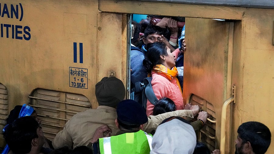 <div class="paragraphs"><p>People board an overcrowded train for Prayagraj's Mahakumbh, at the New Delhi railway station, Saturday, Feb. 15, 2025. </p></div>