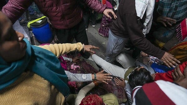 <div class="paragraphs"><p> A man falls amid a huge rush of passengers for boarding an overcrowded train for Prayagraj's Mahakumbh, at the New Delhi railway station, Saturday, Feb. 15, 2025.  </p></div>