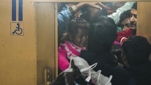 <div class="paragraphs"><p>Passengers board an overcrowded train for Prayagraj's Mahakumbh, at the New Delhi railway station, Saturday, Feb. 15, 2025. At least 18 people were killed and more than a dozen injured in a stampede that broke out late Saturday night at the crowded railway station.</p></div>