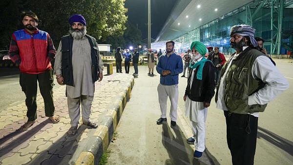 <div class="paragraphs"><p>Relatives wait outside the airport ahead of the second batch of the immigrants' arrival from the US, in Amritsar, Saturday.</p></div>