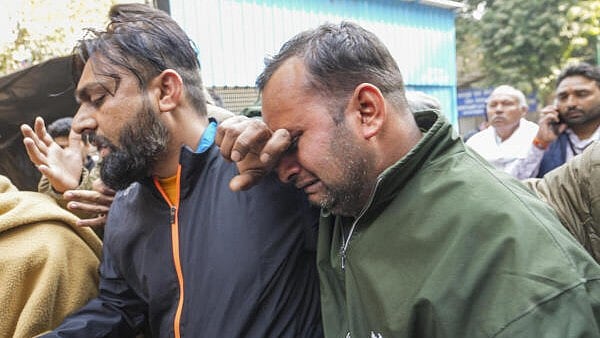 <div class="paragraphs"><p>Grieving relatives of Sangeeta Malik, a woman from Haryana who died in New Delhi railway station stampede, outside the mortuary at the RML Hospital, in New Delhi, Sunday, Feb. 16, 2025. At least 18 people were killed and more than a dozen injured in a stampede that broke out late Saturday night at the crowded New Delhi railway station.</p></div>