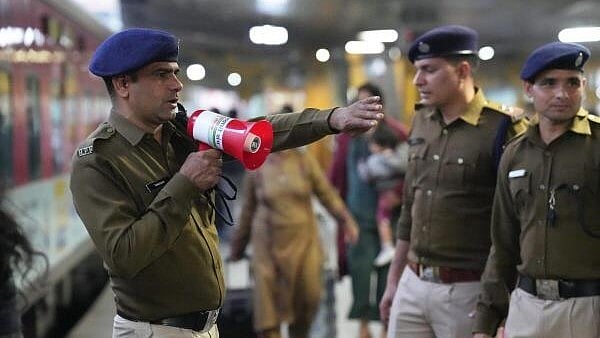 <div class="paragraphs"><p>A RPF official makes announcements through a loudspeaker at the New Delhi Railway Station, in New Delhi, Sunday.</p></div>