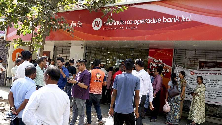 <div class="paragraphs"><p>People gather outside a branch of the New India Co-operative Bank in Mumbai.&nbsp;</p></div>