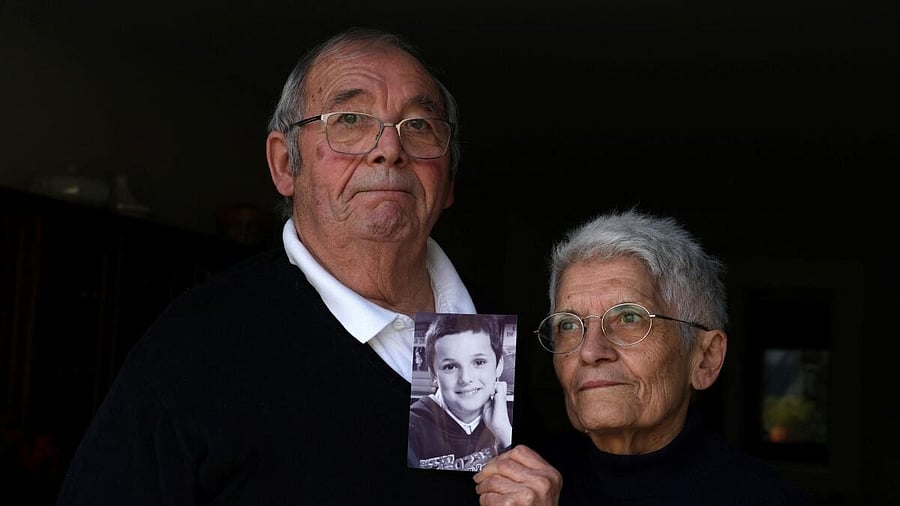 <div class="paragraphs"><p>Roland and Mauricette Vinet hold a photo of their grandson Mathis Vinet at their home in Saint-Germain near Poitiers, before the opening of the trial in Vannes of French ex-surgeon Joel Le Scouarnec, accused of the aggravated rape and sexual assault against hundreds of children during three decades.</p></div>