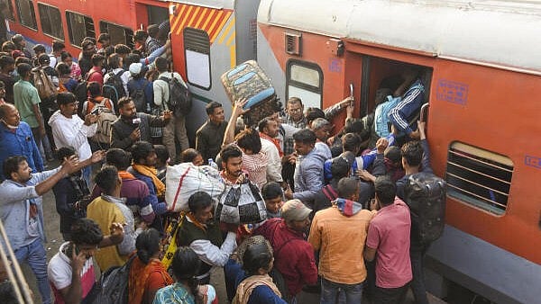 <div class="paragraphs"><p>Passengers jostle to board a train at a railway station, amid the ongoing ‘Maha Kumbh Mela’ festival of Prayagraj, in Patna</p></div>