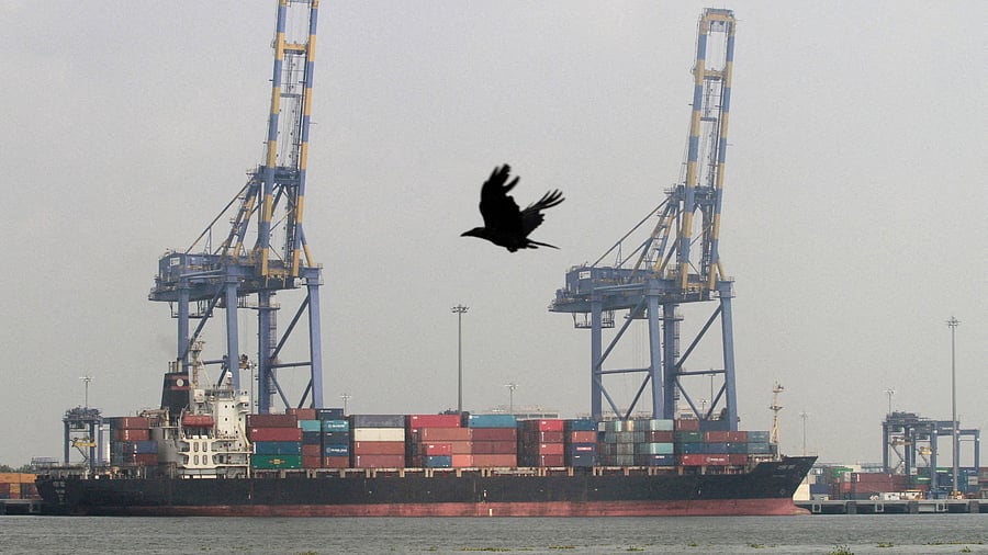 <div class="paragraphs"><p> A crow flies past a container ship docked at a port in Vallarpadam in the southern Indian city of Kochi </p></div>