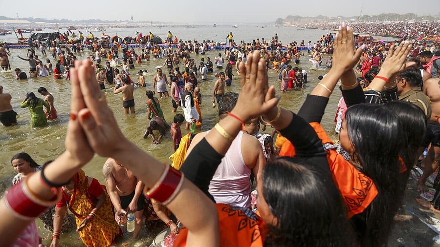 <div class="paragraphs"><p>Devotees offer prayers as they take a holy dip at Sangam during the ongoing ‘Maha Kumbh Mela’ festival, in Prayagraj, Uttar Pradesh.</p></div>