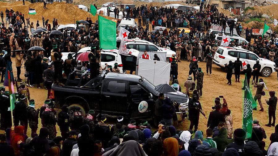 <div class="paragraphs"><p>Palestinian militants and members of the Red Cross gather near vehicles on the day Hamas hands over deceased hostages Oded Lifschitz, Shiri Bibas and her two children Kfir and Ariel Bibas, seized during the deadly October 7, 2023 attack, to the Red Cross, as part of a ceasefire and hostages-prisoners swap deal between Hamas and Israel, in Khan Younis in the southern Gaza Strip February 20, 2025. </p></div>