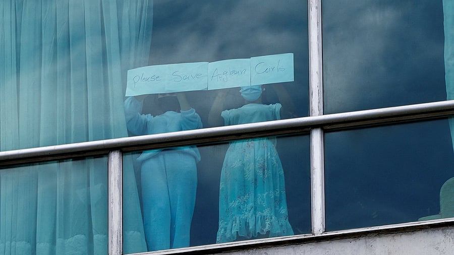 <div class="paragraphs"><p>Women hold a sign at a hotel where migrants from Asia and the Middle East are housed after being deported to Panama as part of an agreement between the administration of U.S. President Donald Trump and the Central American nation, in Panama City, Panama </p></div>
