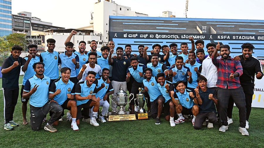 <div class="paragraphs"><p>FC Agniputhra, winners of the BDFA Super Division League Championship, pose with the George Hoover Cup at the Bangalore Football Stadium on Thursday. </p></div>