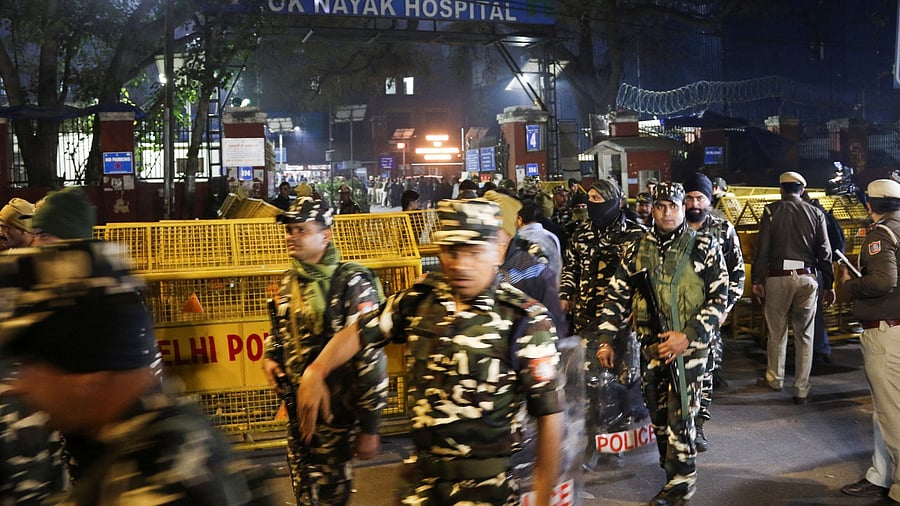 <div class="paragraphs"><p>Security personnel stand guard outside of the Lok Nayak Hospital, where bodies and injured victims were brought in after the stampede incident at the New Delhi Railway Station.</p></div>